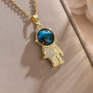 Luxury gold astronaut star necklace with sparkling crystals on elegant silk background