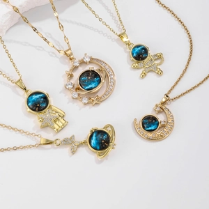 Luxurious astronaut and planet gold necklaces set with blue nebula stones and zircons