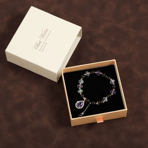 Purple crystal star charm bracelet with beaded design in a luxury jewelry gift box