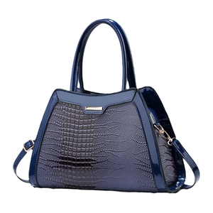 Navy blue faux crocodile skin handbag with shiny finish and adjustable shoulder strap