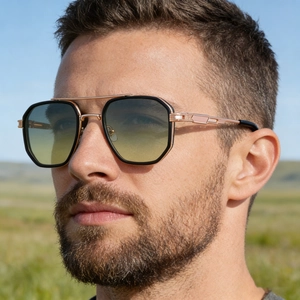 Close-up of square double-bridge sunglasses with rose gold temples and gradient lenses