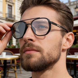 Close-up of retro aviator photochromic sunglasses with black frames and double bridge