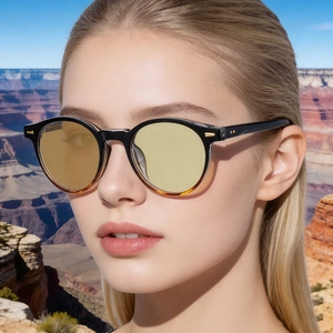 Front view of round sunglasses with amber lenses and tortoise frame on a model