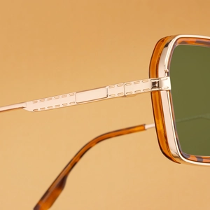 Macro detail of tortoiseshell frame and golden metal temple with rectangle grooves