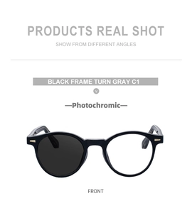 Detail showing transition of photochromic lenses from clear to grey on round black glasses