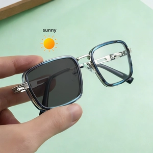 Detailed view of square photochromic sunglasses with metal hinges and blue accents