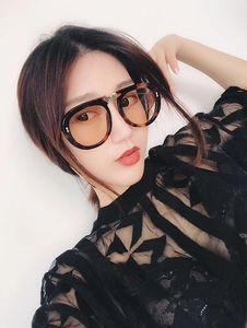 Detail of oversized tortoiseshell sunglasses with rhinestone metal accents on female model