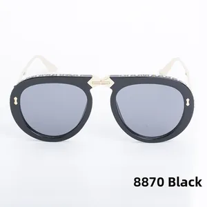 Detail of folding sunglasses featuring rhinestone-studded frames and golden metal temples