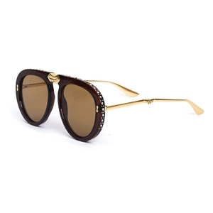 Close-up of diamond-studded frame and golden metal temples on retro folding sunglasses