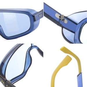 Detail view of steampunk sunglasses featuring blue frames, yellow tips, and metal hinges