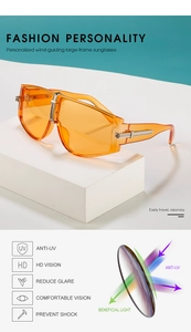 Detail of oversized orange sunglasses featuring silver metal hinges and HD UV protection