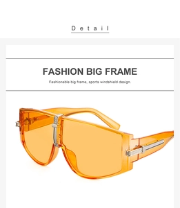Detail of orange big frame sunglasses featuring a sleek integrated windshield lens design