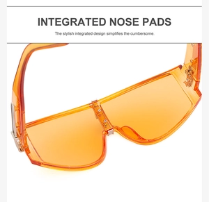 Detail view of integrated nose pads and silver metal hinges on orange sunglasses