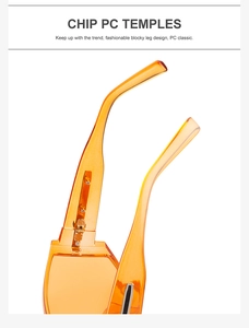 Detail view of transparent orange sunglasses showing thick PC temples and metal hinge
