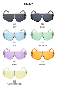 Detail view of seven oversized shield sunglasses in various vibrant colors and metal bridge