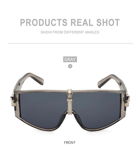 Front detail of gray oversized sunglasses with metal hardware and gray lenses