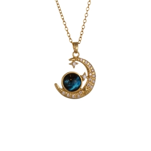 Elegant gold celestial necklace featuring a crescent moon with starry crystal charms