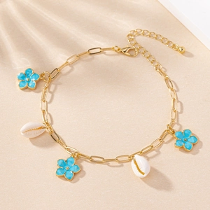 Golden paperclip chain bracelet with blue enamel flowers and natural sea shells