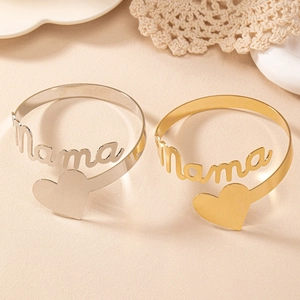Vue détaillée de bracelets ouverts or et argent avec lettrage Mama et motif coeur