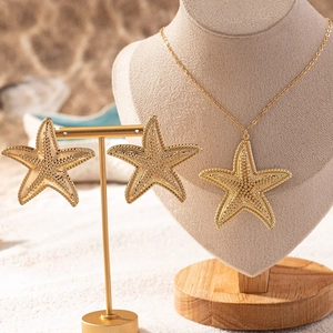 Elegant gold starfish pendant necklace and earrings set with fine granulated texture