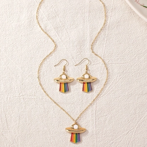Detailed view of the gold UFO necklace and earring set with vibrant rainbow beam design