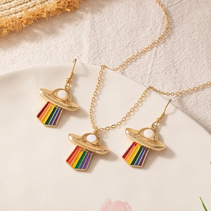 Rainbow UFO jewelry set with gold pendant necklace and matching drop earrings on a tray