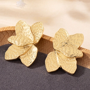 Elegant gold flower stud earrings with textured petals and high-gloss metallic finish