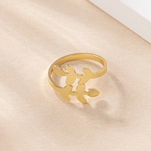 Detail of a minimalist gold leaf open ring with polished olive branch cross design