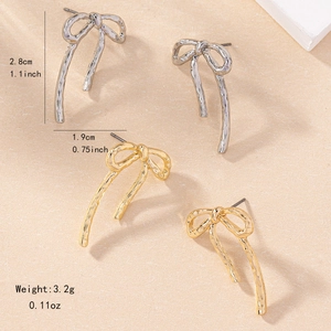 Textured metal bow earrings in gold and silver finish with liquid metal ripples