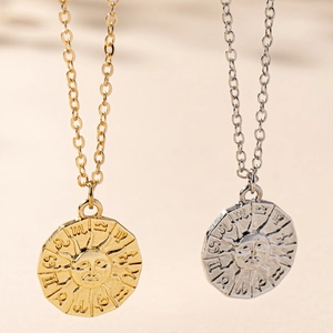 Detailed view of gold and silver sun coin pendants with zodiac embossed symbols