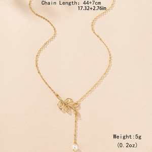 Elegant gold necklace with hollow leaf pendant and small pearl on a matte background