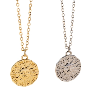 Gold and silver zodiac sun coin necklaces with celestial symbols and engraved pendants