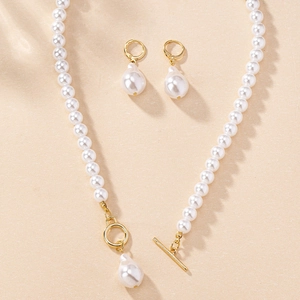 Detail of elegant gold OT toggle necklace and matching teardrop pearl earring set