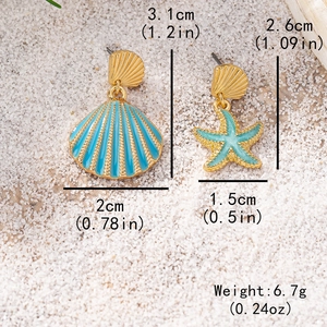 Asymmetric starfish and seashell drop earrings in gold and blue on white sand