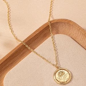 Elegant gold coin necklace featuring a hollow rose relief and twisted rope edge detail