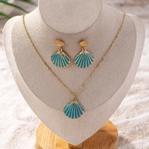 Golden seashell jewelry set with blue enamel necklace and earrings on a bust display