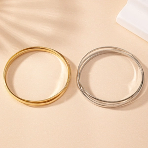 Detailed top view of minimalist layered triple band bangles in gold and silver finish