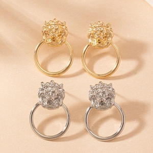 Detailed view of lion head earrings in gold and silver finish with textured relief
