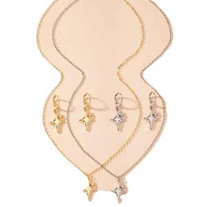 Elegant four-pointed star jewelry set with gold and silver necklaces and hoop earrings
