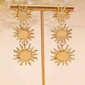 Vintage golden triple sun drop earrings with hand-hammered texture on elegant metal stand