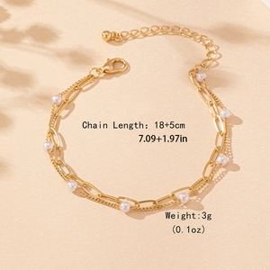 Elegant double-layer gold chain bracelet with white pearls and lobster clasp closure