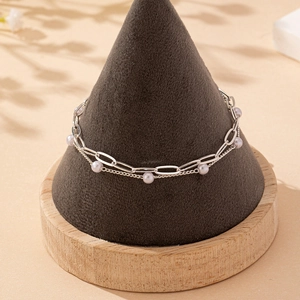 Elegant double-layered silver chain bracelet featuring white pearls and paperclip links
