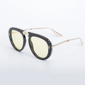Foldable rhinestone sunglasses with black frames, yellow lenses and gold metal temples