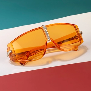 Oversized orange translucent shield sunglasses with silver and gold metal accents