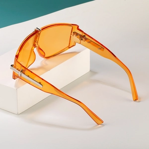 Fashionable oversized orange sunglasses with futuristic flat top shield frame for women