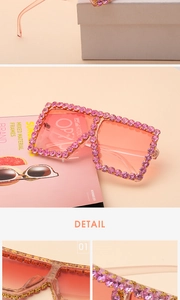 Macro detail of oversized square sunglasses with purple rhinestones and gradient lenses