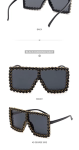 Detail view of square oversized sunglasses with black rhinestones and gray lenses