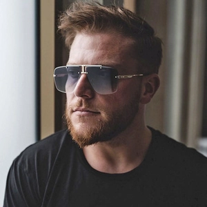 Close-up of men's square rimless sunglasses with gold metal bar and grey gradient lenses