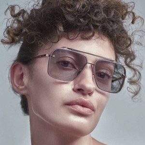 Close-up of steampunk square metal sunglasses with light purple gradient lenses on model