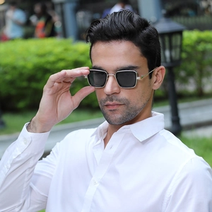 Steampunk square sunglasses for men with silver metal frame and black lenses outdoors